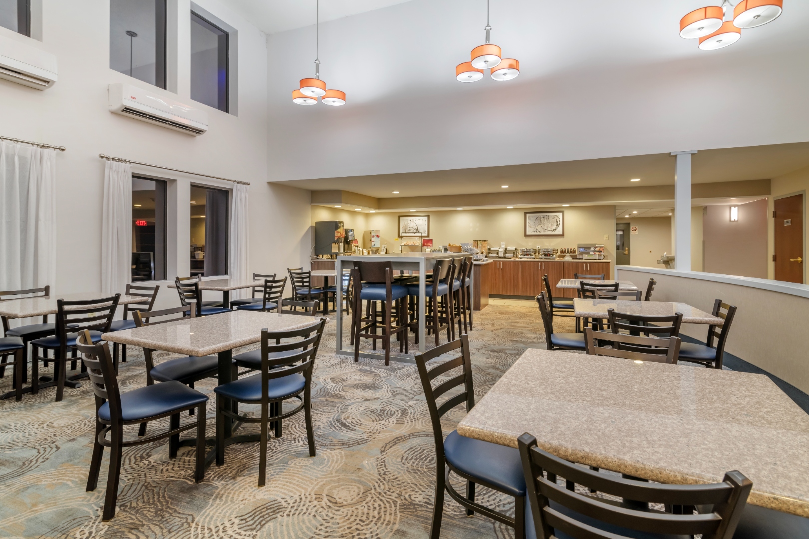 Bright breakfast area serving complimentary hot breakfast at Syracuse Grand