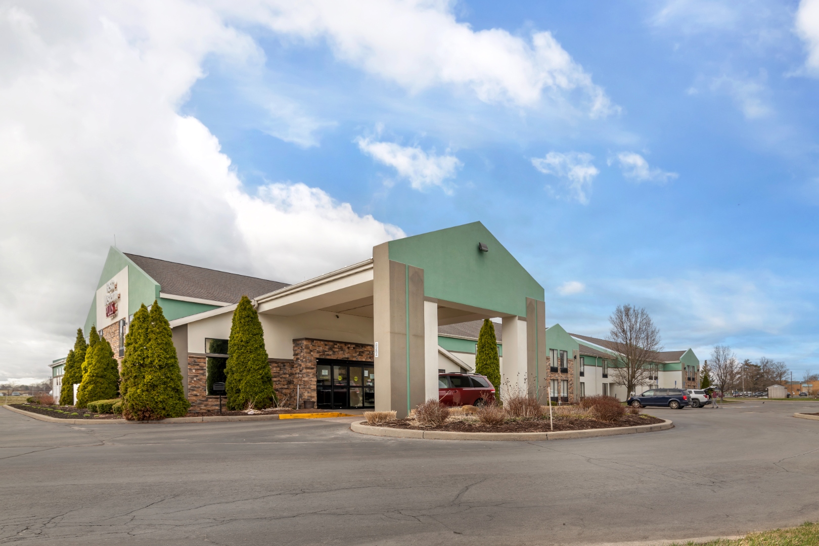 Syracuse Grand hotel exterior at dusk in Liverpool, NY near Syracuse Hancock International Airport and Lockheed Martin Electronics Park
