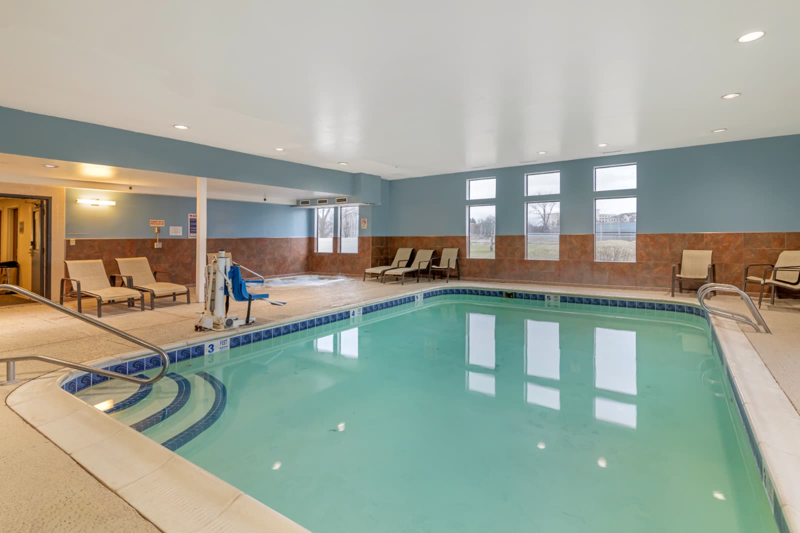 Heated indoor pool with hot tub at Syracuse Grand hotel in Liverpool, NY